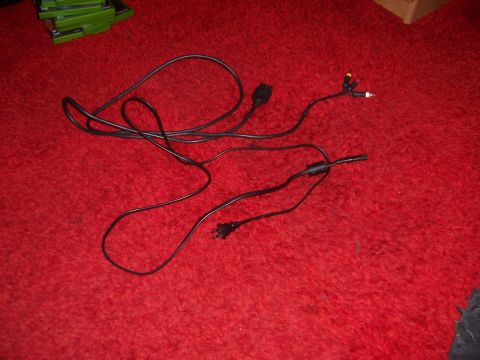 1997 Ford Probe - Various electronic cables and adapters are spread out on a textured red surface.