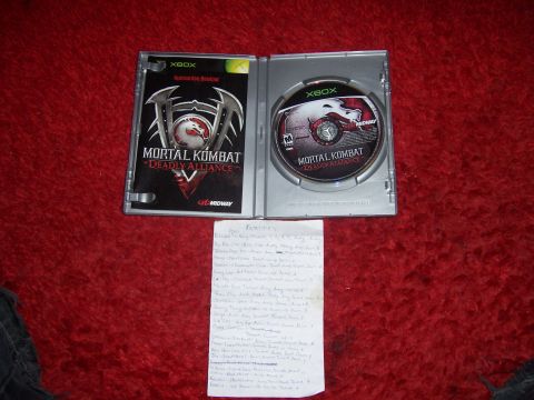 1997 Ford Probe - Mortal Kombat Deadly Alliance game case and disc are shown with a handwritten list of items.