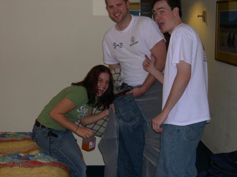 1997 Ford Probe - A group of friends are gathered in a room, with one person holding a bottle.