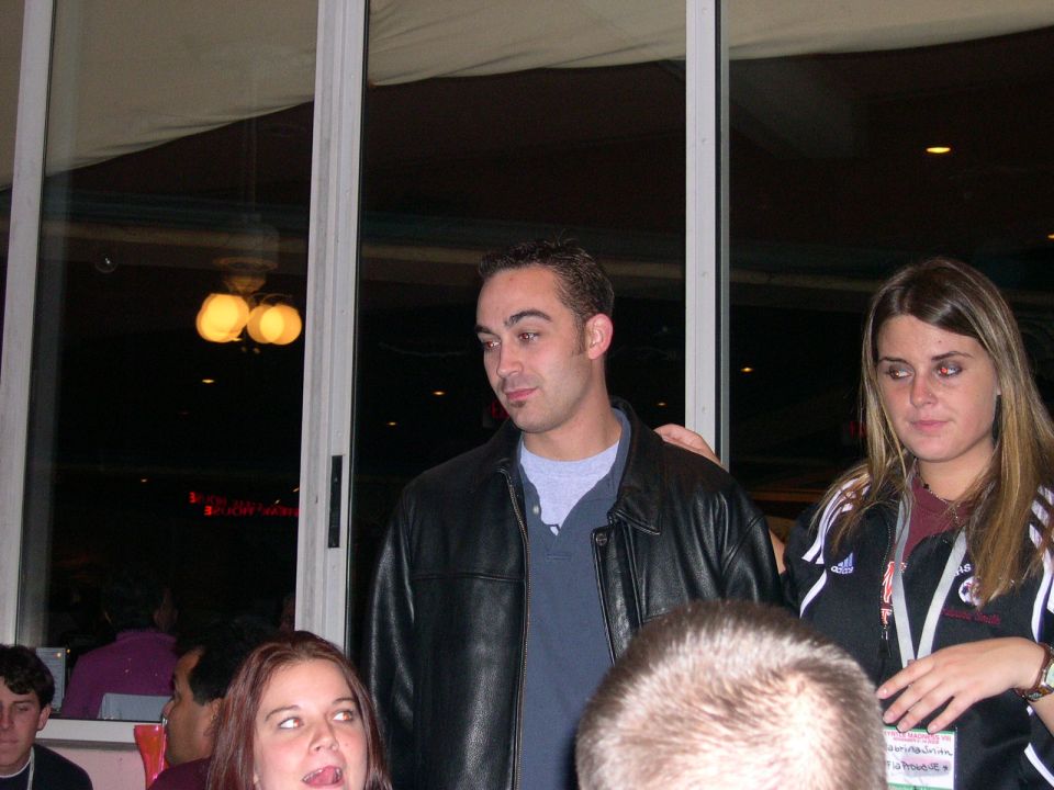 People gathered indoors, some looking at the camera