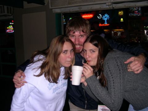 1997 Ford Probe - Three friends share a drink from a single cup in this candid photo.