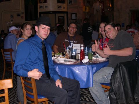 1997 Ford Probe - A group of people are gathered around a table in a restaurant, enjoying a meal and drinks.