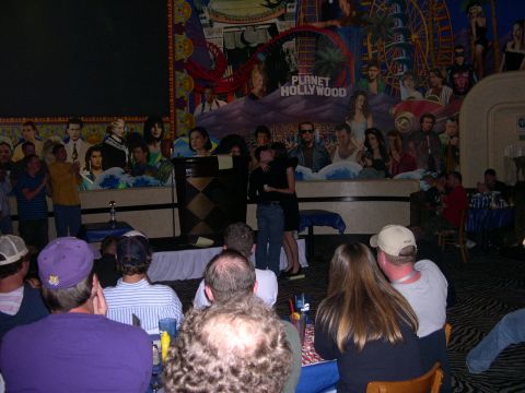 1997 Ford Probe - A crowd watches a presentation in front of a large mural depicting movie stars and attractions at Planet Hollywood.