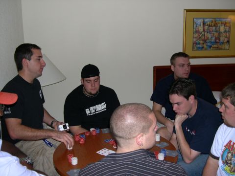 1997 Ford Probe - Men gathered around a table for a poker game, with chips and cards spread out.