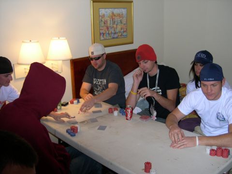 1997 Ford Probe - A group of people are gathered around a table, engrossed in a game of poker, with chips and cards spread out before them.