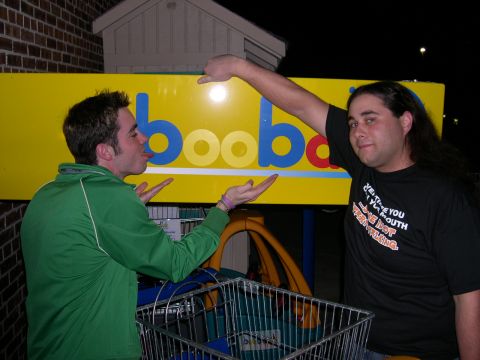 1997 Ford Probe - Two men pose in front of a brightly colored sign at night, with a shopping cart in the foreground.
