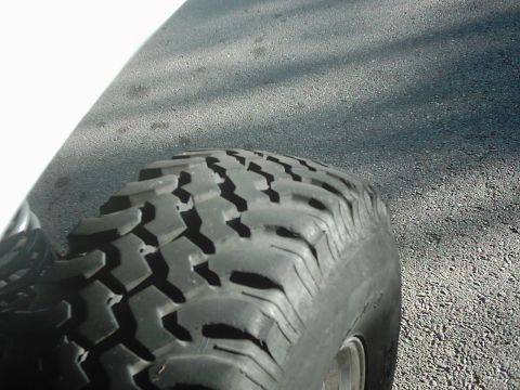 1978 Ford Bronco - Close-up of a tire tread on asphalt. The image is from a vehicle enthusiast's registry album.