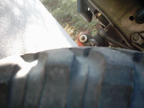 1978 Ford Bronco - A close-up view of a vehicle's suspension system, showing mechanical components and a tire.