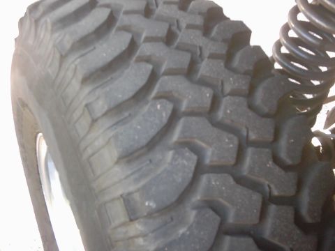 1978 Ford Bronco - A close-up view of a tire and suspension component is visible.
