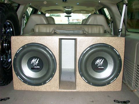 2000 Ford Excursion - A custom speaker box with dual MA Audio subwoofers is installed in the rear cargo area of a 2000 Ford Excursion.