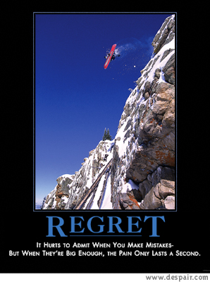 2001 Ford Crown Victoria - A snowboarder takes a leap off a steep, snow-covered mountain face against a clear blue sky.