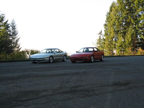 1994 Ford Probe - Two 1994 Ford Probes are seen parked on an asphalt surface with trees in the background. The registry label may be wrong.