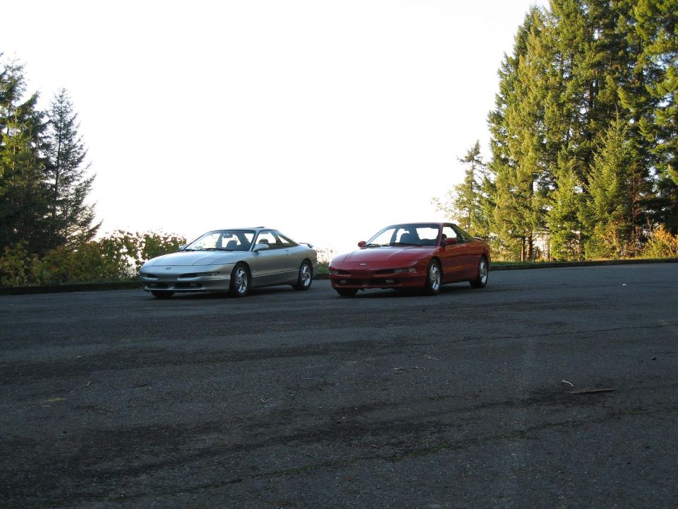 Silver and red 1994 Ford Probes parked side-by-side