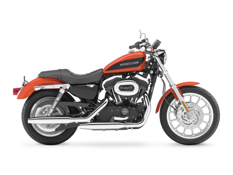 Orange and black motorcycle, side view, on white background
