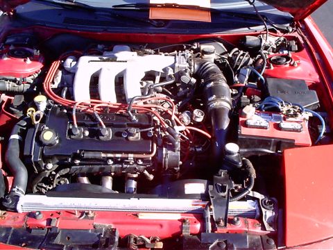 1995 Ford Probe - Close-up view of a car's engine bay, showing various components and wiring.
