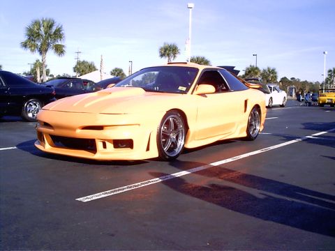 1995 Ford Probe - A modified 1995 Ford Probe with a custom body kit and hood scoop is parked in a lot.