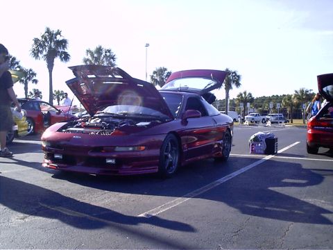 1995 Ford Probe - A purple 1995 Ford Probe is displayed with its hood and trunk open at an outdoor car event.