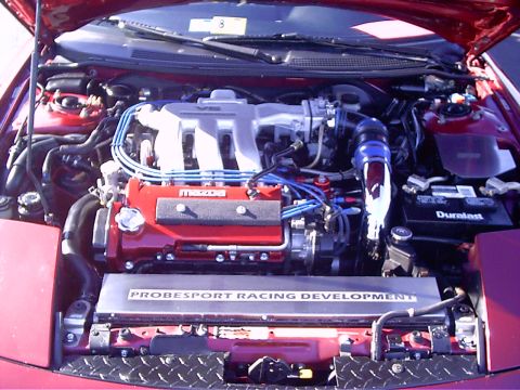 1995 Ford Probe - Engine bay view of a red vehicle, showing the V6 engine and racing development branding.