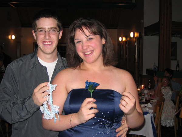 Man in a gray shirt and woman in a blue dress smiling