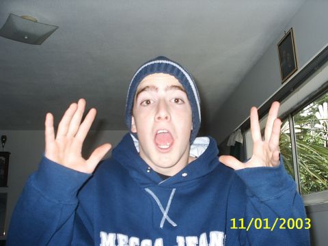 1989 Ford Bronco - A young man with a surprised expression poses for a photo indoors, hands held up in the air.