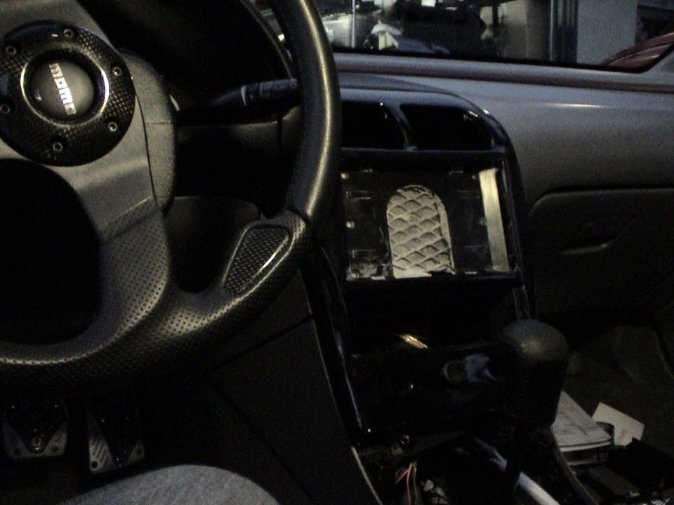 Car interior with Momo steering wheel and open dashboard slot