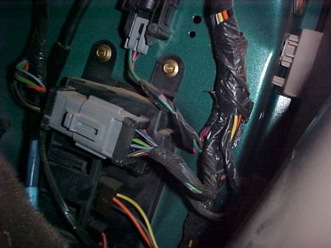 1997 Ford Expedition - A complex wiring harness with various colored wires is visible, connected to a gray electrical component.