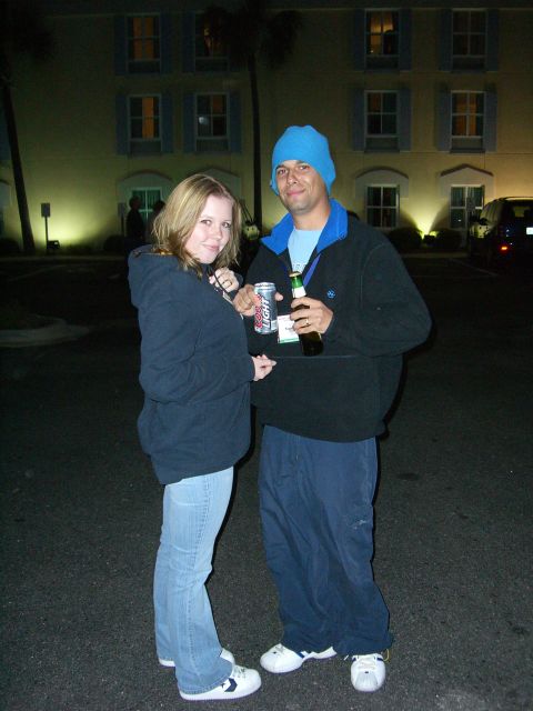 1996 Ford Probe - Couple holding drinks in front of a hotel at night.