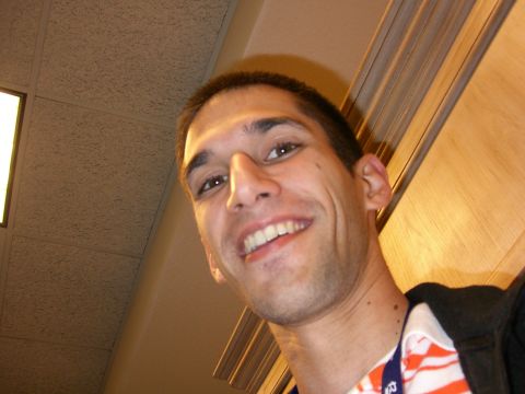 1996 Ford Probe - A man smiles for a selfie in an indoor environment, with wood paneling and a drop ceiling visible in the background.