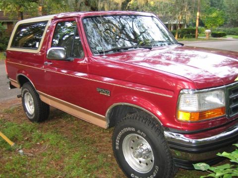 1994 Ford Bronco - This red Ford Bronco has a two-tone paint scheme with tan trim and a white removable hardtop.