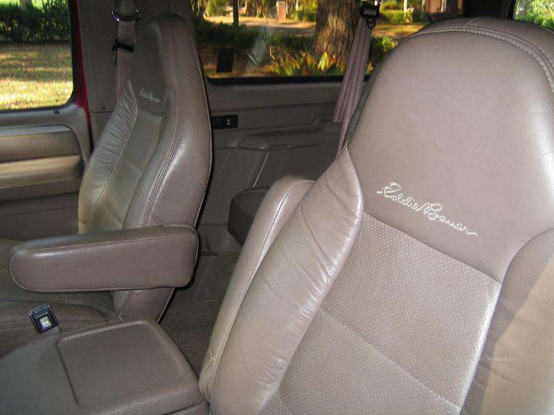 Tan leather Eddie Bauer seats in a 1994 Ford Bronco, showing embroidered script on the headrest and perforated inserts