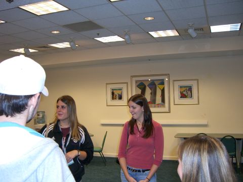 1996 Ford Probe - Several people are standing and talking in a room that appears to be a meeting space or classroom.