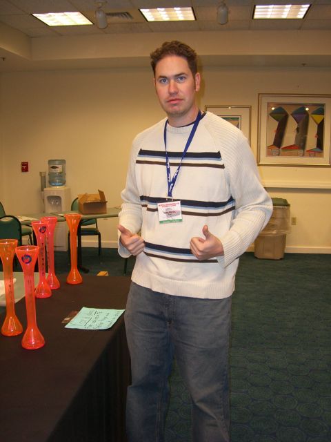 1996 Ford Probe - Man in a striped sweater and jeans stands indoors, giving a double thumbs-up gesture.