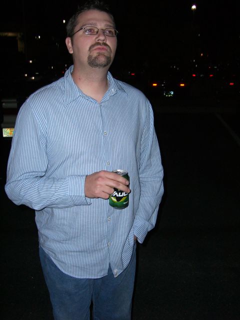 1996 Ford Probe - A man stands in the dark, holding a can of soda and looking off to the side.