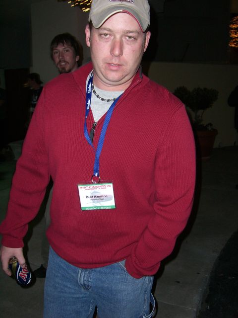 1996 Ford Probe - Man with a name tag at an event, holding a beverage can.