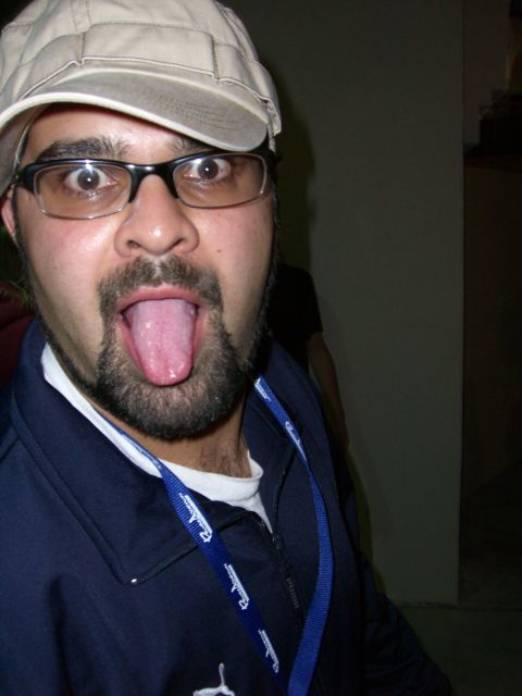 1996 Ford Probe - A person makes a funny face while wearing a cap and glasses, with a lanyard around their neck.