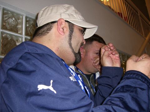 1996 Ford Probe - Two men are engaged in conversation, with one in the foreground wearing a cap and a blue Puma jacket.