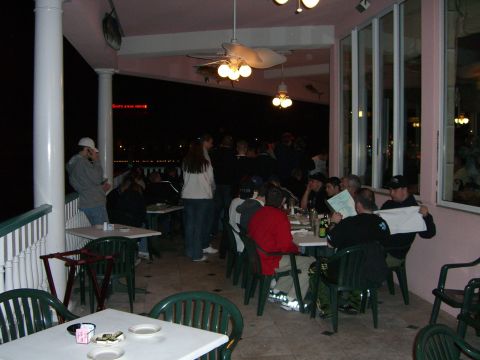 1996 Ford Probe - A group of people are gathered on an outdoor patio at night, seated at tables and appearing to be dining.