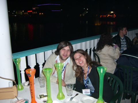1996 Ford Probe - A group of people are seated at a table outdoors at night, with several tall, colorful glasses on the table.