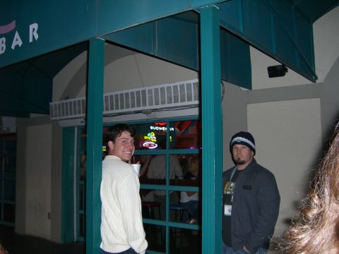 1996 Ford Probe - Two men are seen standing outside a bar, with a Budweiser sign illuminated inside.