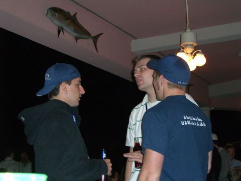 1996 Ford Probe - A group of men are gathered indoors, with a taxidermied fish mounted on the ceiling above them.