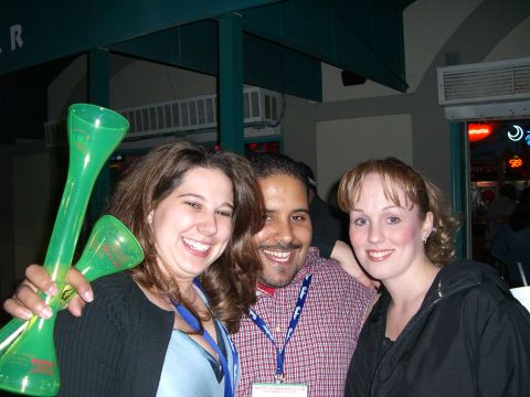 1996 Ford Probe - Three friends share a happy moment, with one person holding up two green novelty horns.