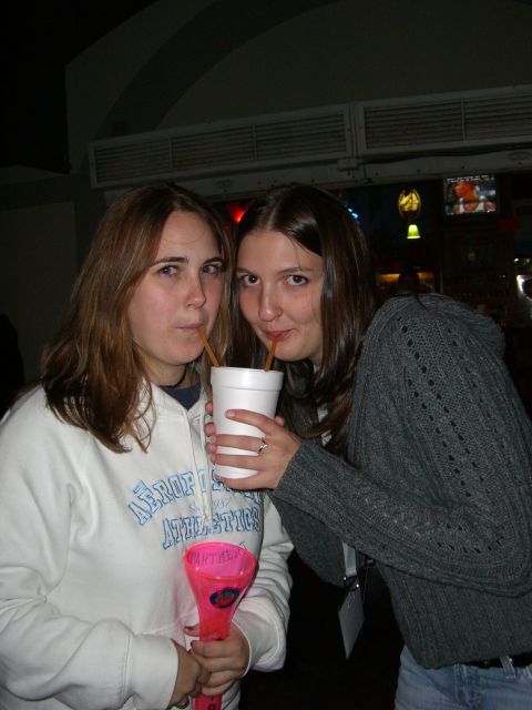 1996 Ford Probe - Two women are sharing a large drink from a white cup with straws, holding a pink novelty cup.