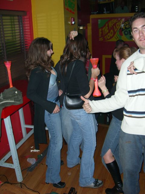 1996 Ford Probe - A group of people are enjoying themselves at a lively bar, with one person giving a thumbs-up.