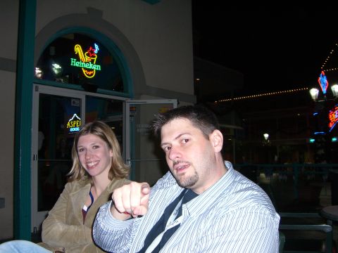 1996 Ford Probe - A couple enjoys a night out at a venue with illuminated signage.