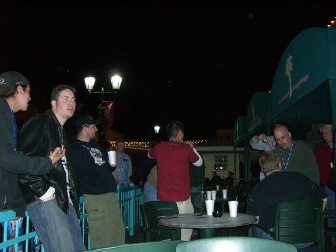 1996 Ford Probe - People socialize outdoors at night under lights and a decorative awning.