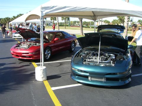 1996 Ford Probe - Two Ford Probes are displayed under tents at an outdoor event.