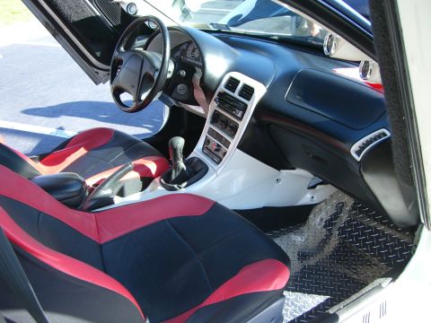 1996 Ford Probe - The interior of a 1996 Ford Probe shows custom red and black seats and a diamond plate floor.