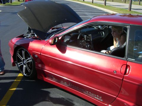 1996 Ford Probe - Customized 1996 Ford Probe with aftermarket wheels and a woman inside.