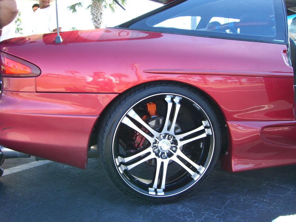 Red car rear quarter panel and custom wheel with orange brake caliper