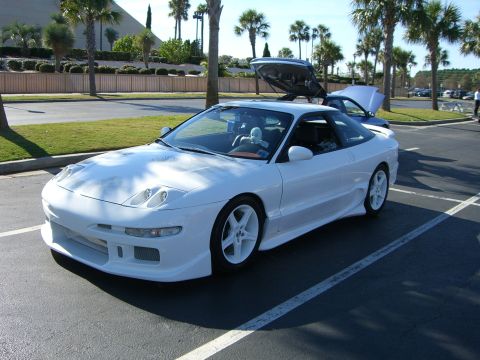 1996 Ford Probe - A white 1996 Ford Probe is parked in a lot with its trunk open, showing off its sporty design.